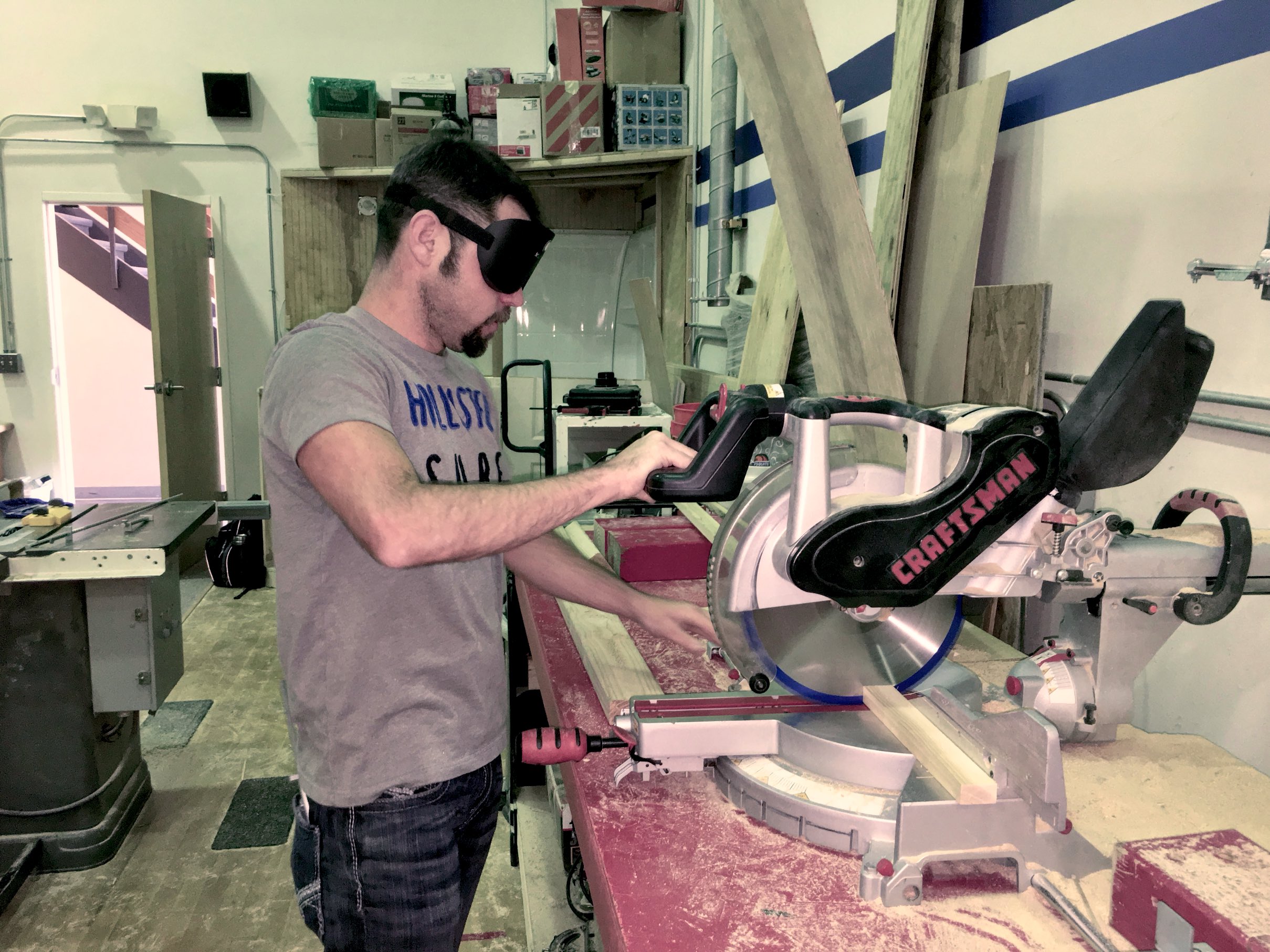Markus makes a cut on the chop saw