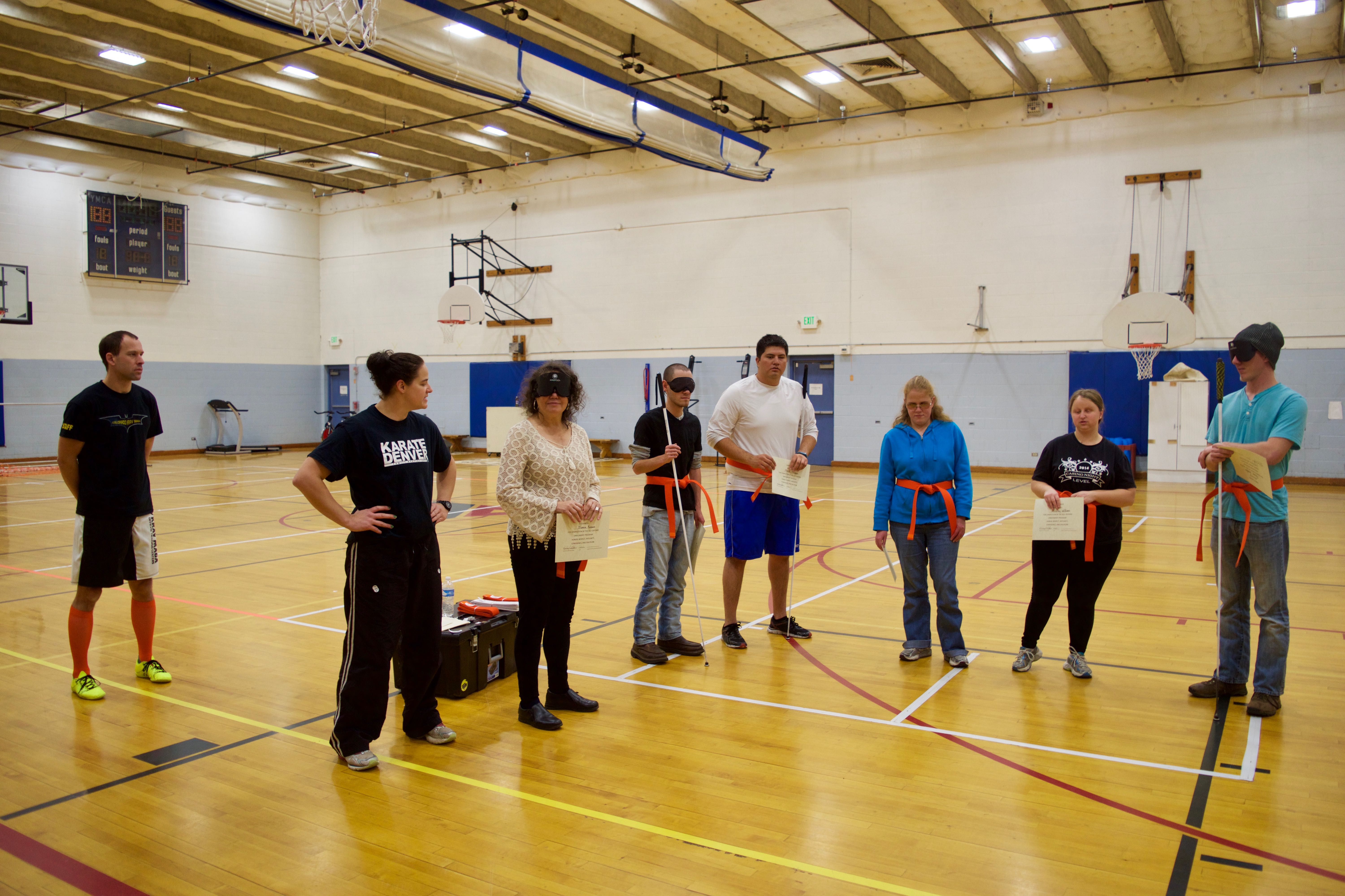 Martial Arts with their orange belts and certificates