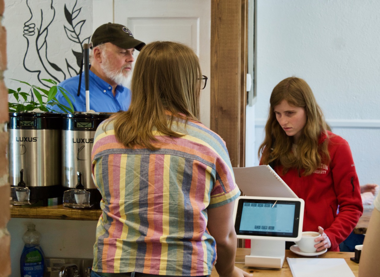 After delivering Braille menus to Dirt Coffee, Rebecca was the first to put one to use.