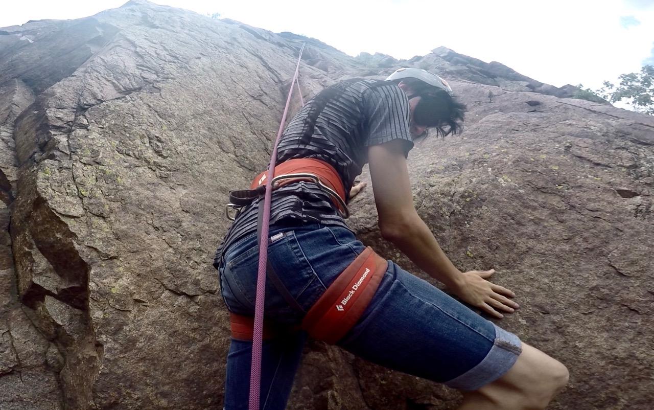 Roland locates a hand hold as he climbs up a steep rock outcrop