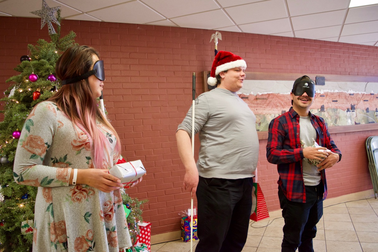 Rudy gets a wide smile when he opens his Secret Santa gift - an Echo Dot