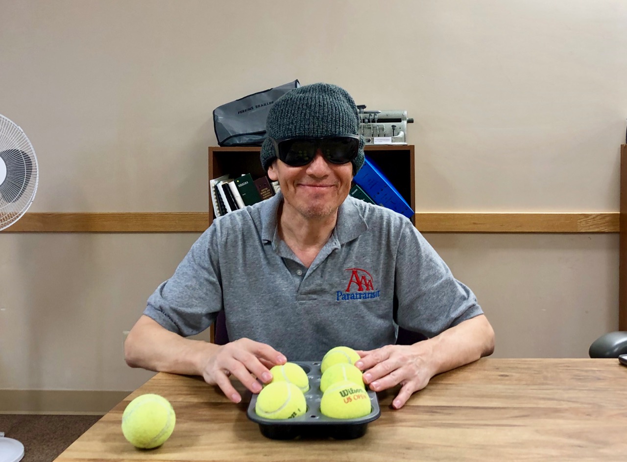 Saul practicing Braille with a muffin tin
