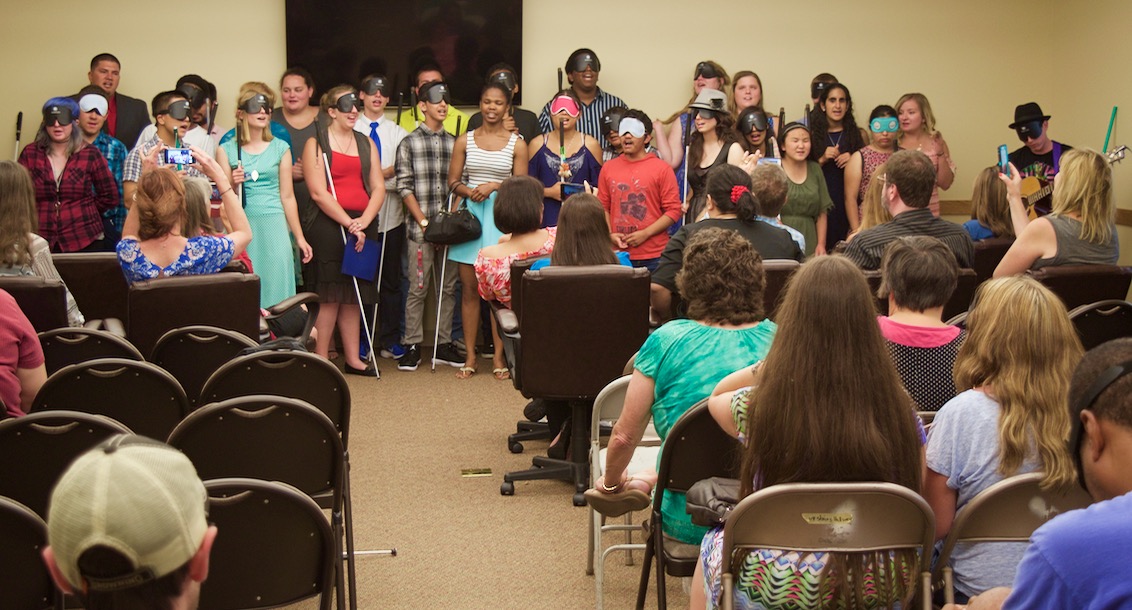 Students and counselors lined up in choir fashion singing