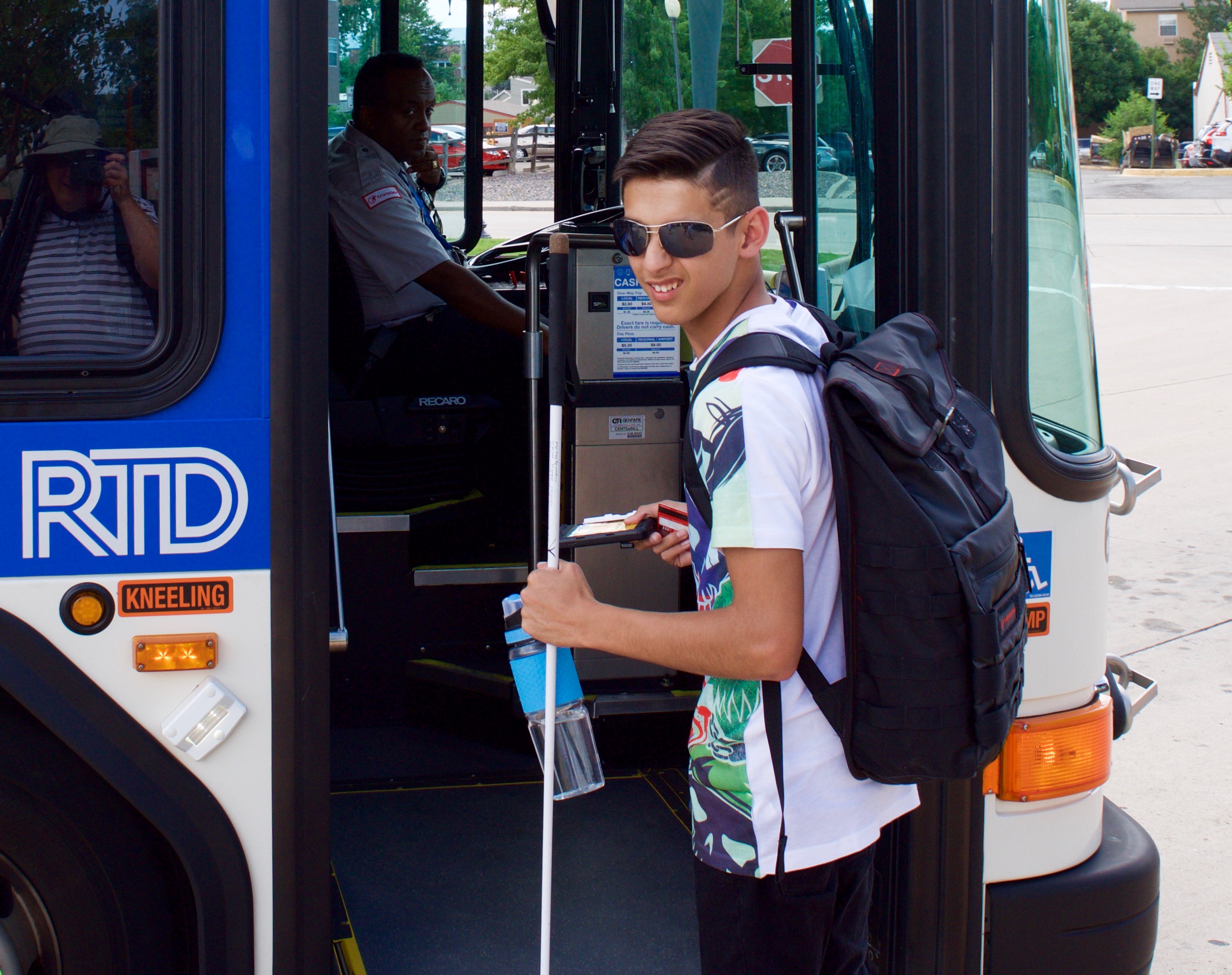 Smiling young man prepares to board the RTD bus