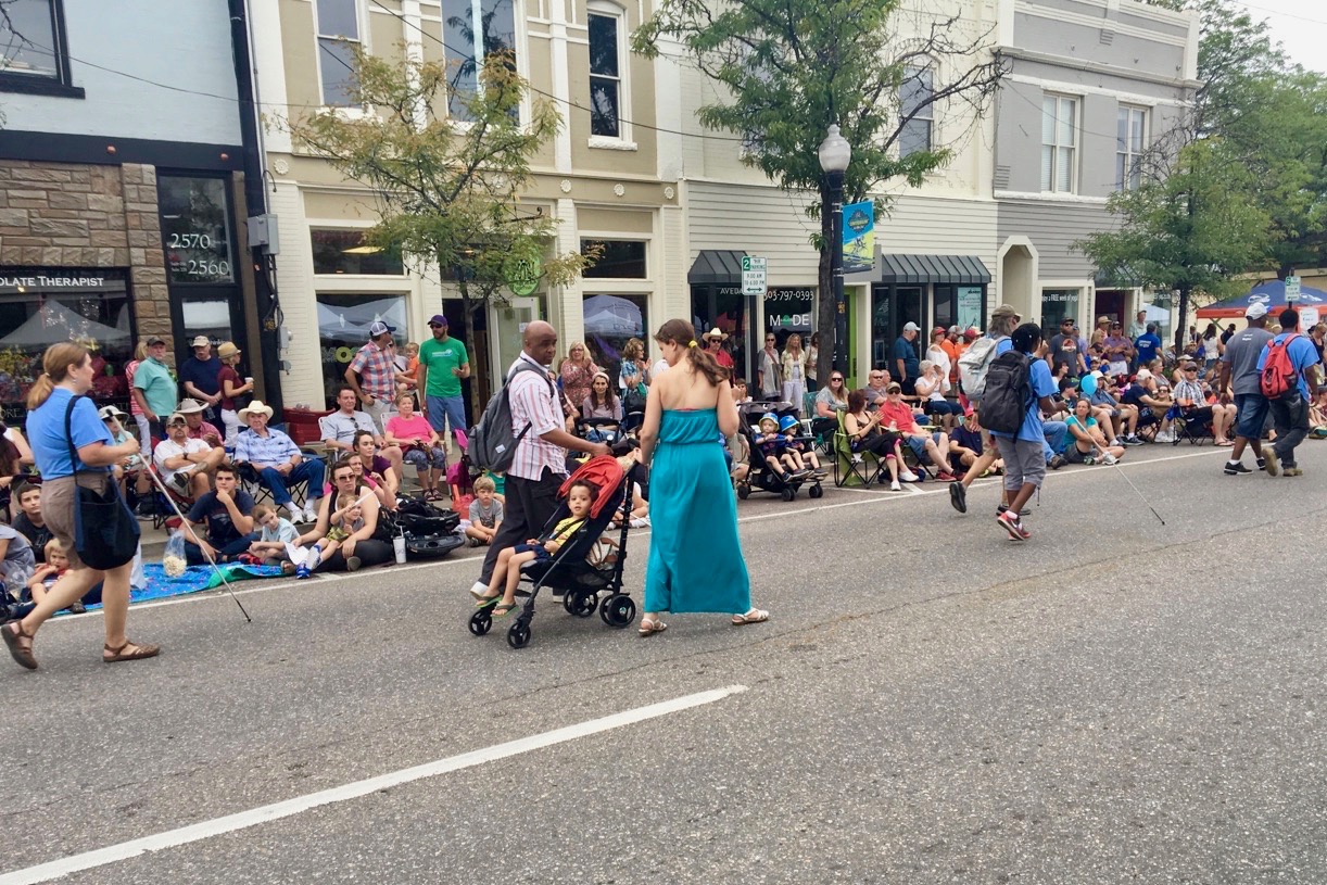 Blind parents Jen and Dishon Spears each have a hand on 2-year-old Mason’s stroller as they march in the parade