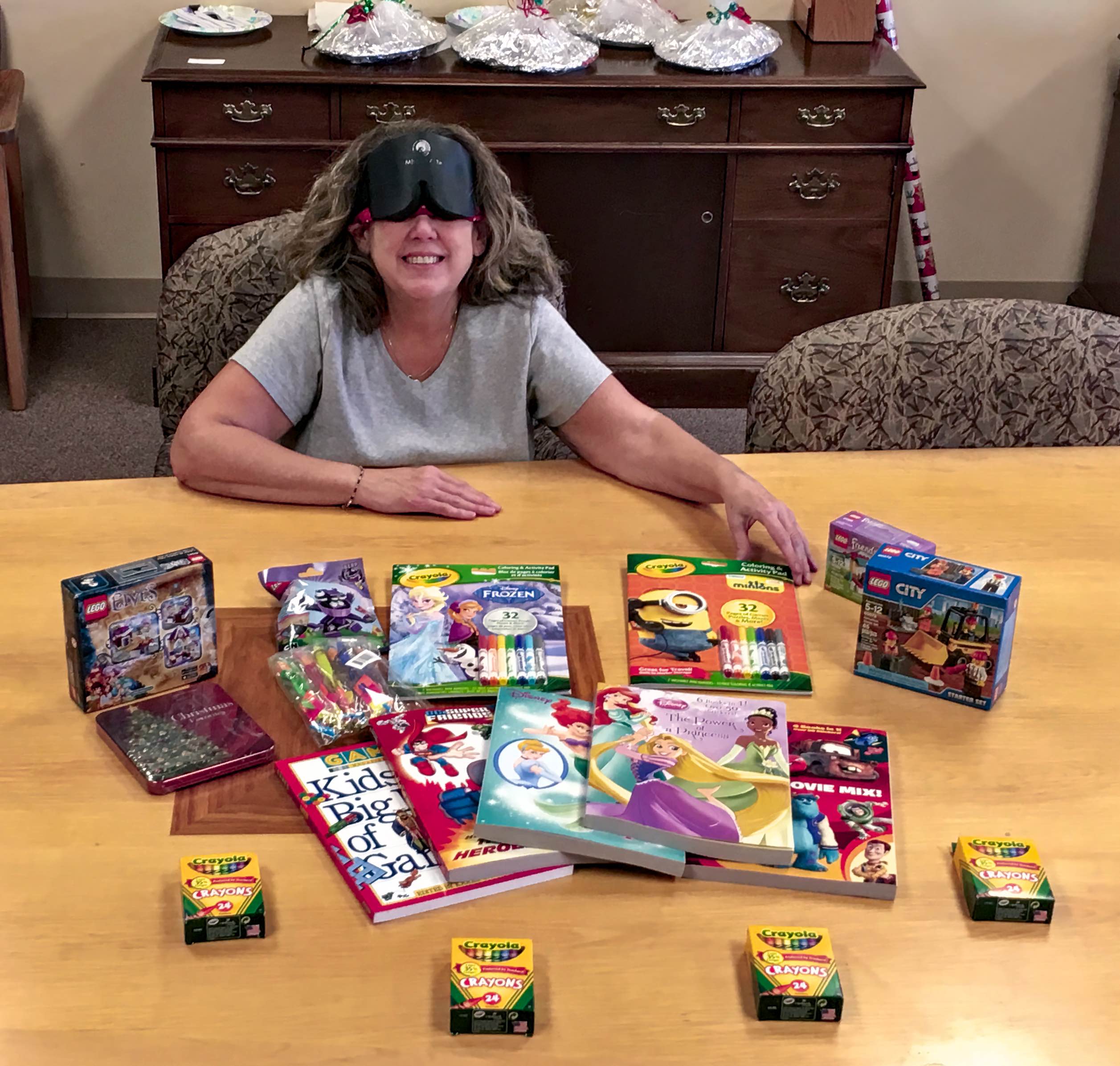A smiling woman displays items she is about to deliver
