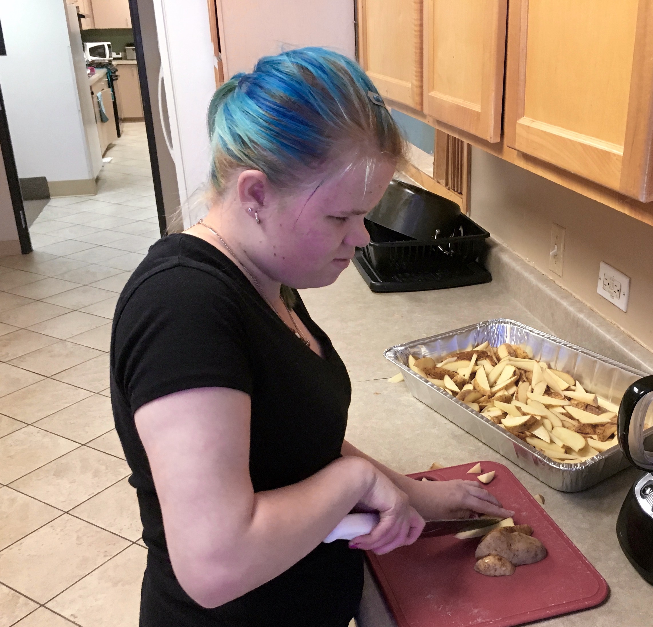 Vika slicing potatoes