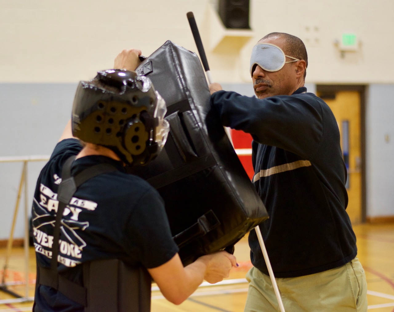 Warren holds on to his cane while throwing elbow jabbs at the pads