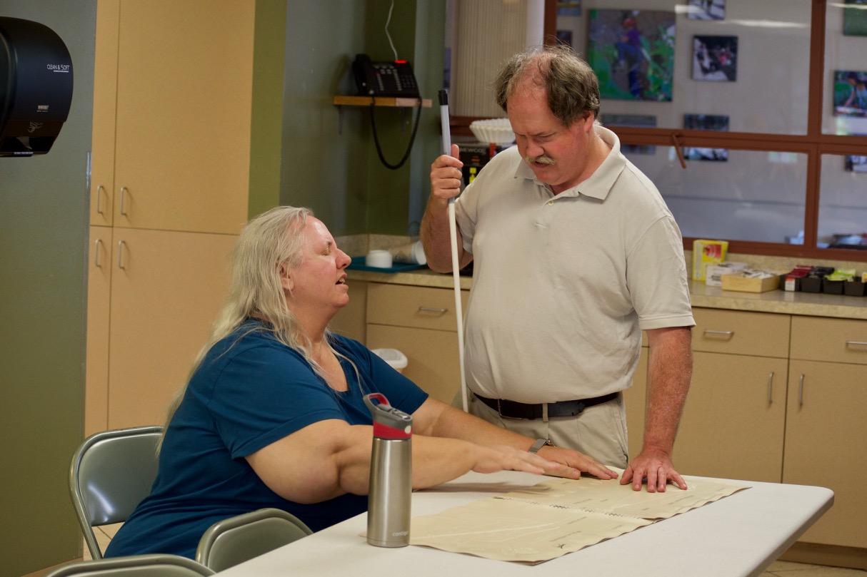 Yolanda and Chip looking at the Eclipse Tactile Graphics