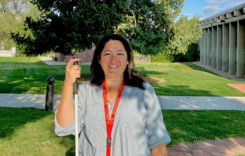 A smiling woman wearing a U.S. Marine lanyard