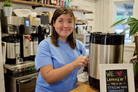 Beth at the coffee machine behind the counter at Dirt Coffee