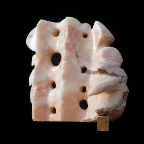 An alabaster sculpture with flowing and spiky elements “Flames and Waves”, Stone carving by Yolanda Thompson