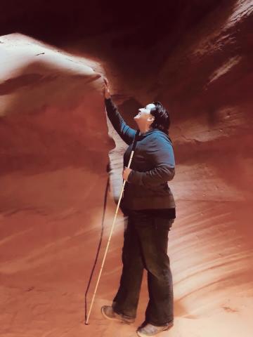 Libby with her cane exploring the wind and water whipped canyon walls at Antalope Canyon Arizona