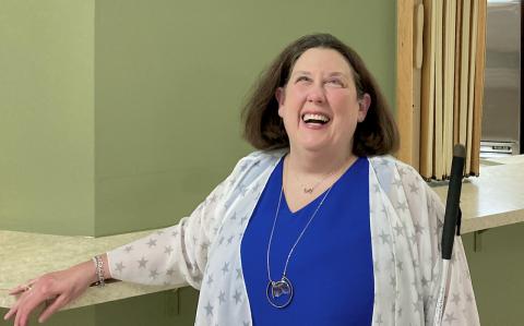 smiling woman shows off her new necklace