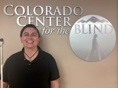 Tiffany Moon in front of the tactile CCB logo
