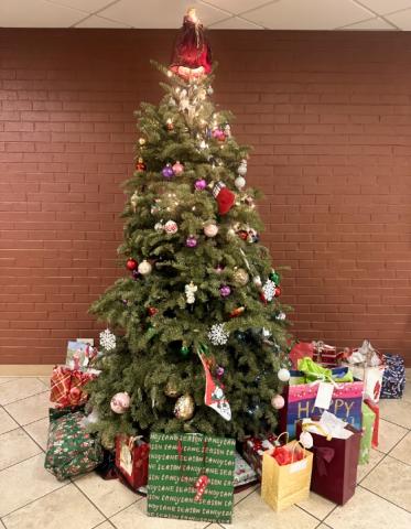 A Lighted Christmas Tree with Presents Below