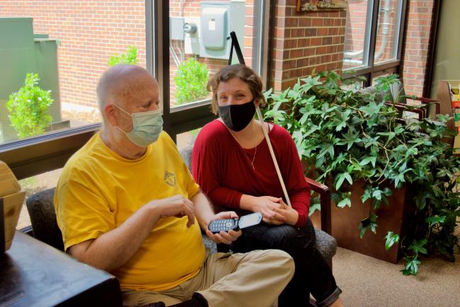 Wayne and Stephanie work on phone skills in the lobby