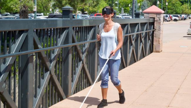 Amanda crossing a bridge near the Light Rail Station