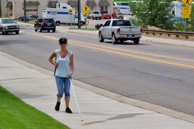 Amanda walking along Prince street with traffic