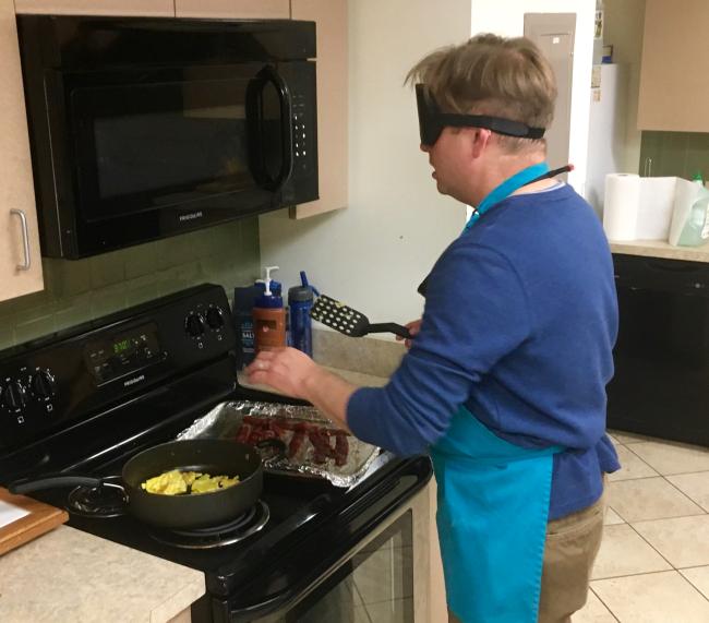 Curt in the kitchen making bacon and eggs