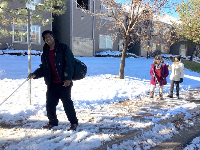 Curtis, Vicki and Mo walk down an ice and snow covered sidewalk in front of the appartments on Sycamore Lots of snow all around