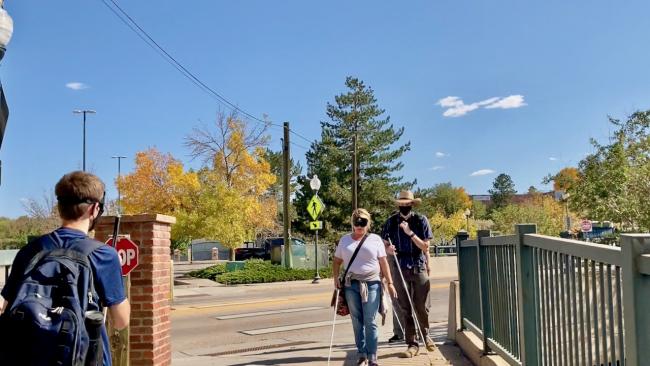 Evan waits as Katie and David come across the entrance to Littles Creek Greenway Trail