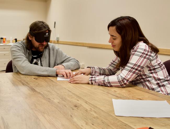 Graham Norwood asks Carina a question in Braille Class