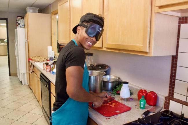 Kameron chopping Bell Peppers for part of his Grad Meal