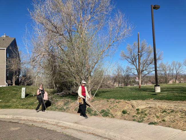 Stefanie walks behind her student around the curve near the Center sidewalk During In Charge Event