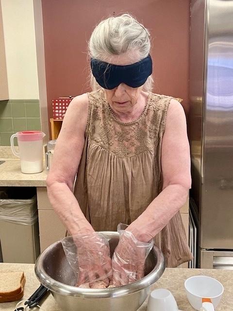 Student works in the kitchen with a mixing bowl