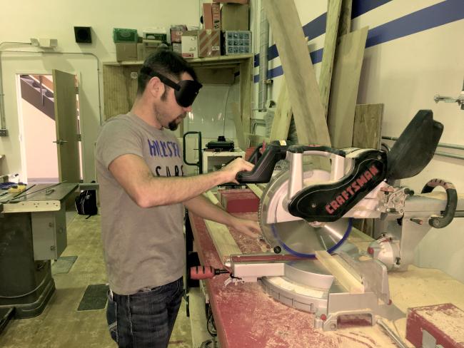 Markus makes a cut on the chop saw