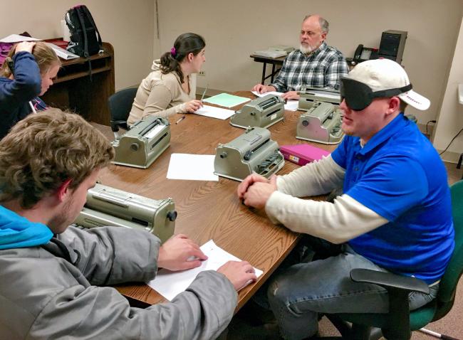 Daniel in College Prep Math class learning about the shapes of printed math symbols