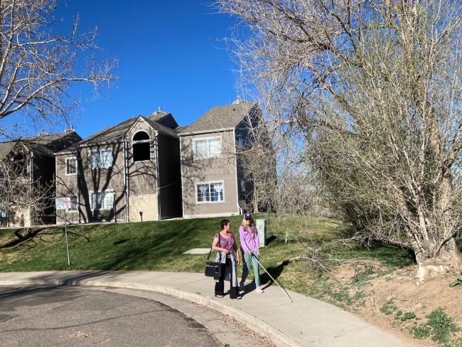 Anne walks with student Terri approaching the center sidewalk
