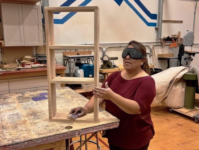 Nina hand-sands her shelf