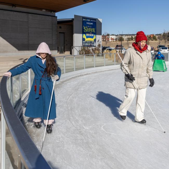 Bella and Taty ice skating with canes