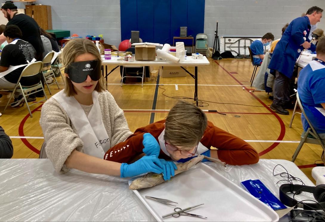 Lindsay helps Jax examine their dog shark.