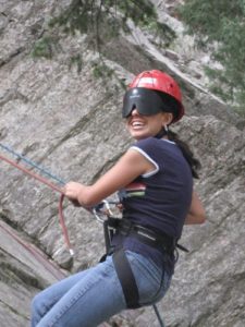 Student rock climbing while attending summer youth program.