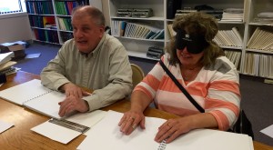 Tom Anderson Reads Braille with a Student