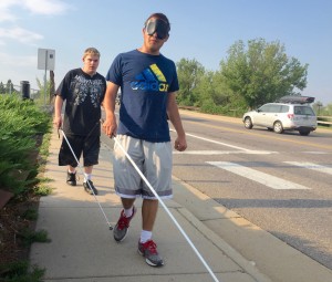 Andy followed by Zach walk with their canes along Prince street on the way to the Bus station
