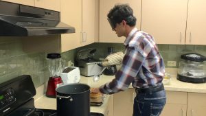 Farhan takes Somosas out of a tall pot of hot oil