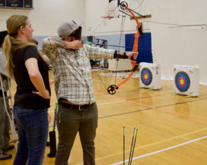 Charles takes aim with his bow in Archery Class