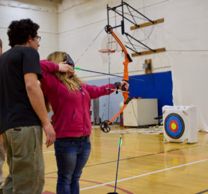 Courtney C working wth Mike from NCSD on aiming her Bow