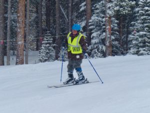 David D. Skiing down the slopes through falling snow