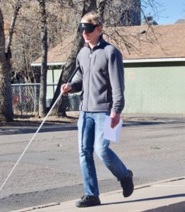 Trevor out walking with his cane and sleepshades