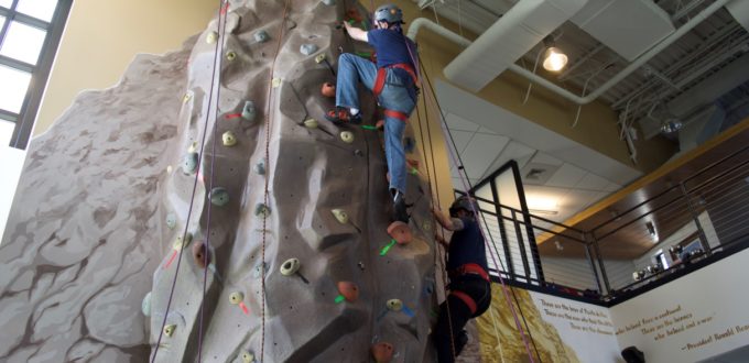 Dugan and Charles both near the top of the climbing wall
