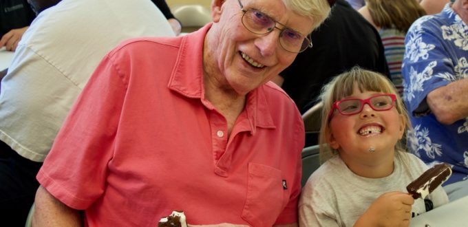 Ron age 83 sitting next to Peityn age 6 both enjoying ice cream