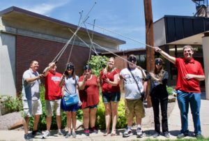 Summer staff with canes crossed in the air