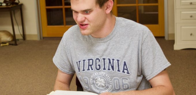 Matt at CCB reading a Braille book
