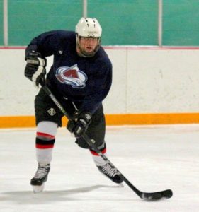 Daniel in full Hockey gear in action on the ice