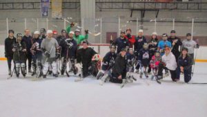 Group photo in full Hockey gear on the ice from the first practice